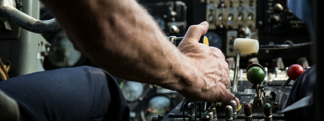 Pilot using plane controls