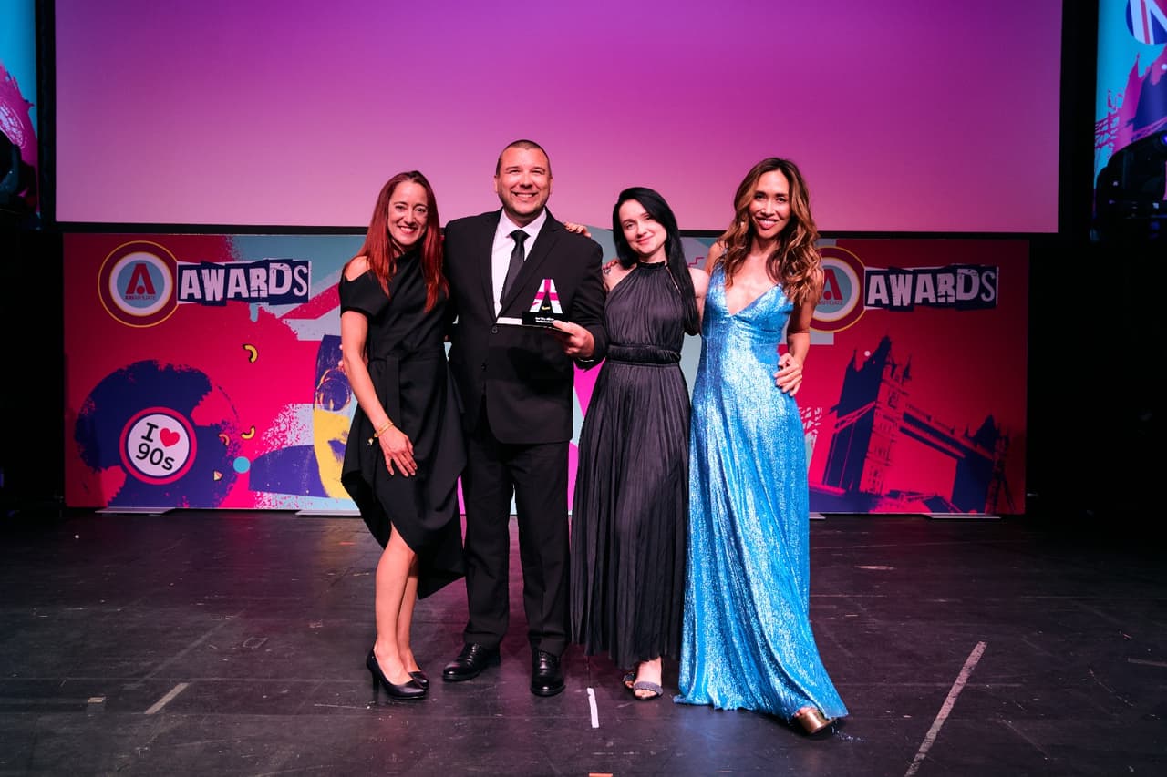 World Poker Deals employees on stage with their iGB Affiliate award