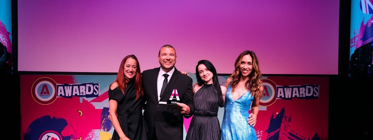 World Poker Deals employees on stage with their iGB Affiliate award